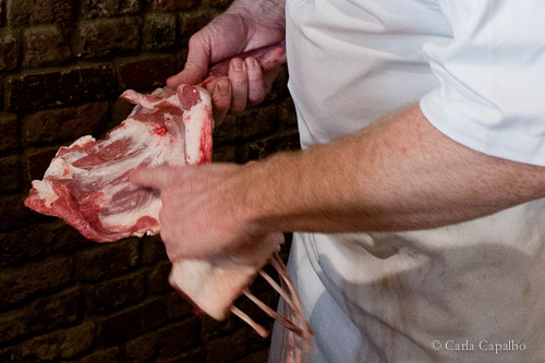 Jonsson shows a customer the lamb before cooking